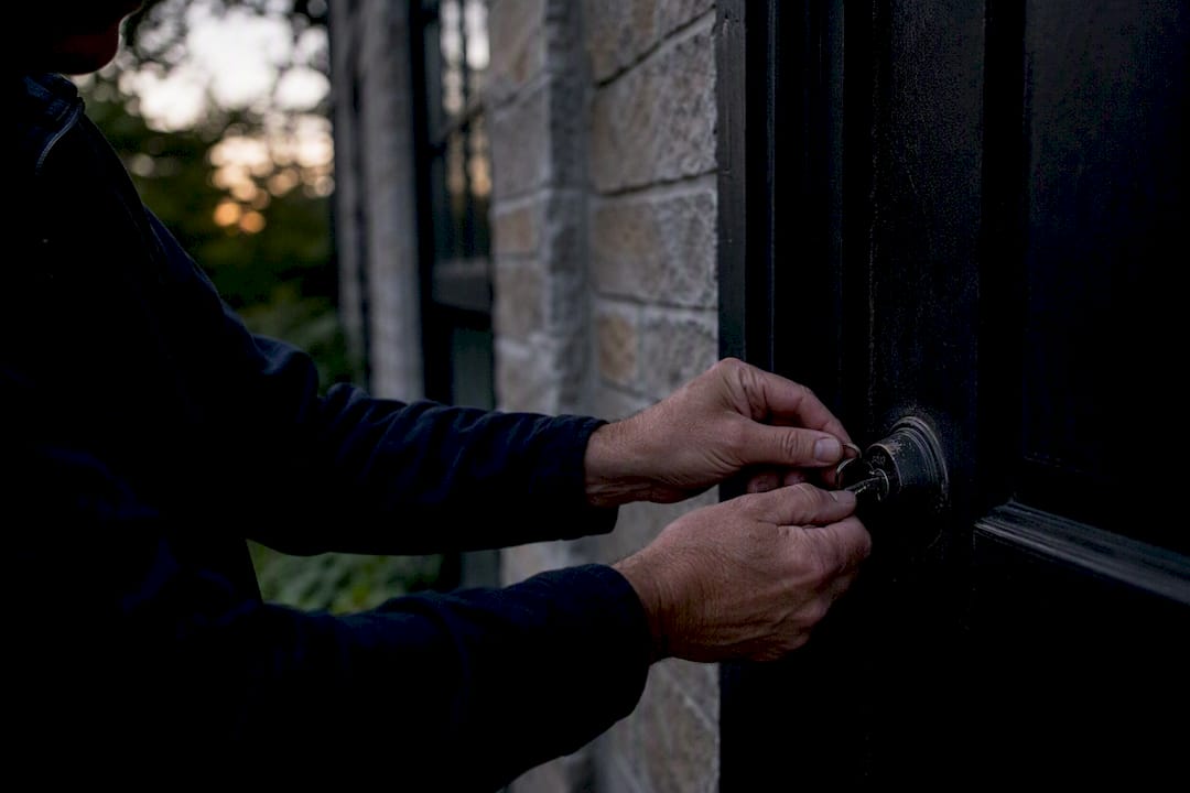 Landlord hands inspecting exterior door lock