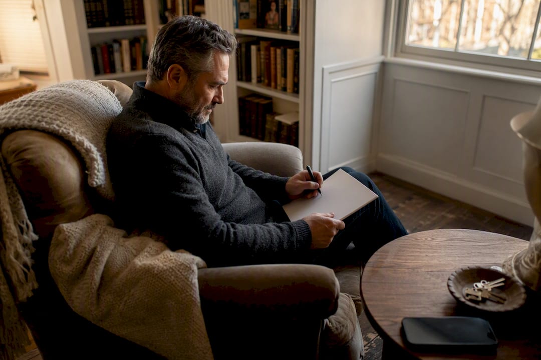 Landlord writing reference letter at desk