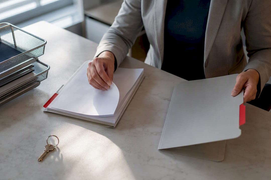 Hands organizing condo insurance documents