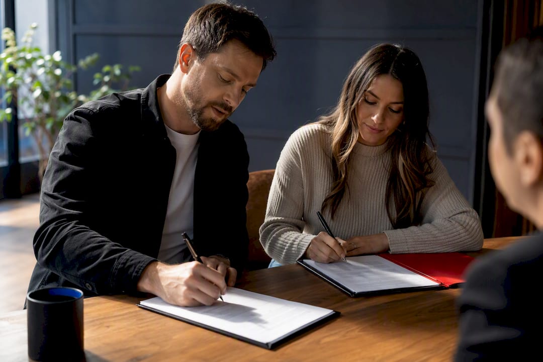 Cosigner signing rental lease with landlord