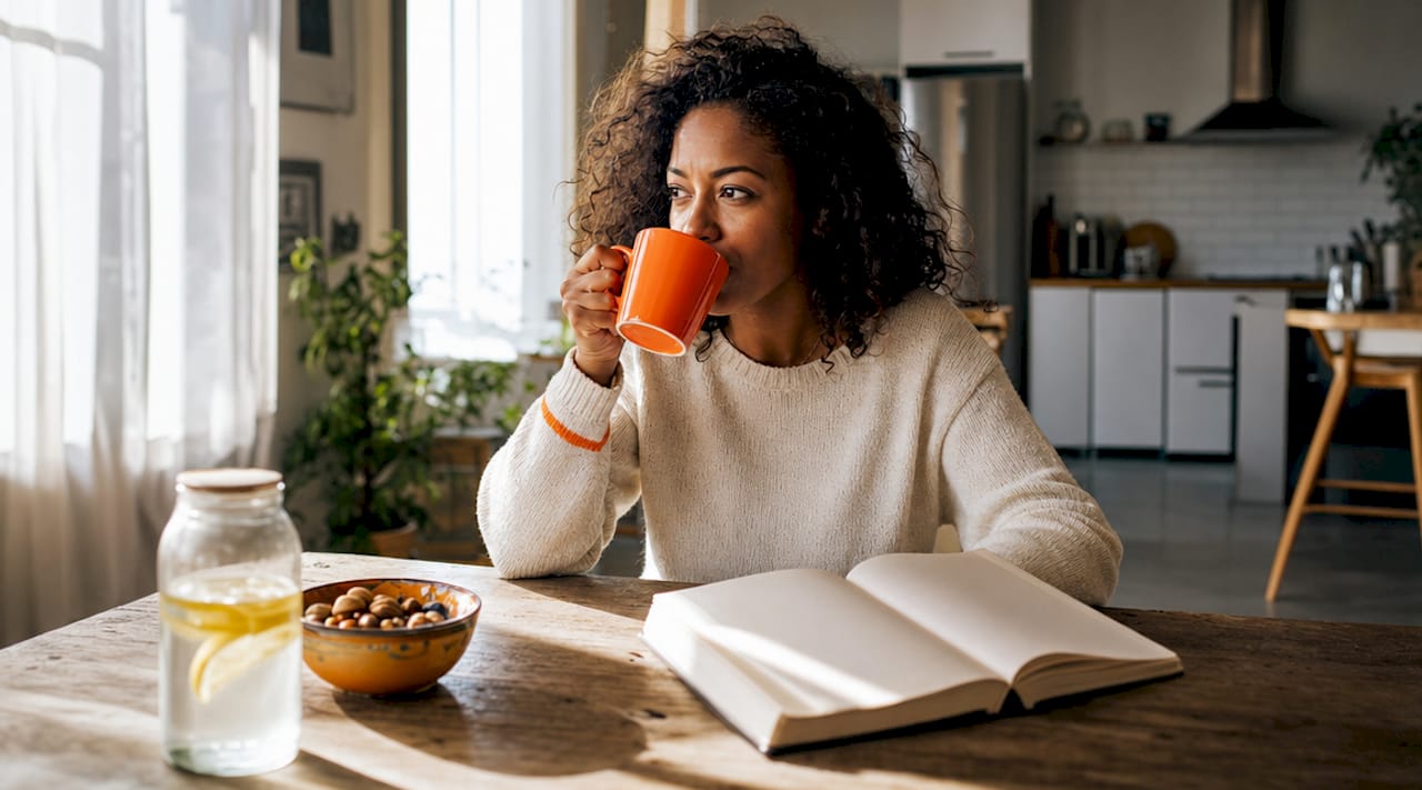 Woman reading about flexible fasting at kitchen island