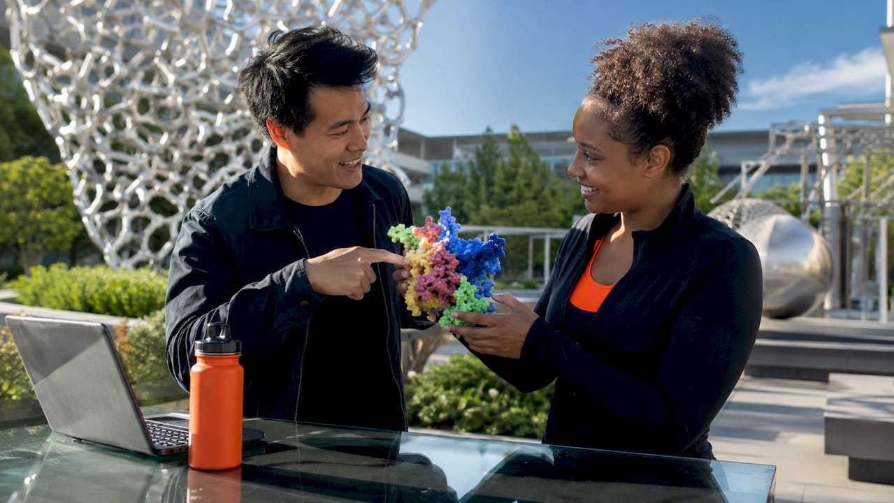 Hands holding molecular model of BDNF protein