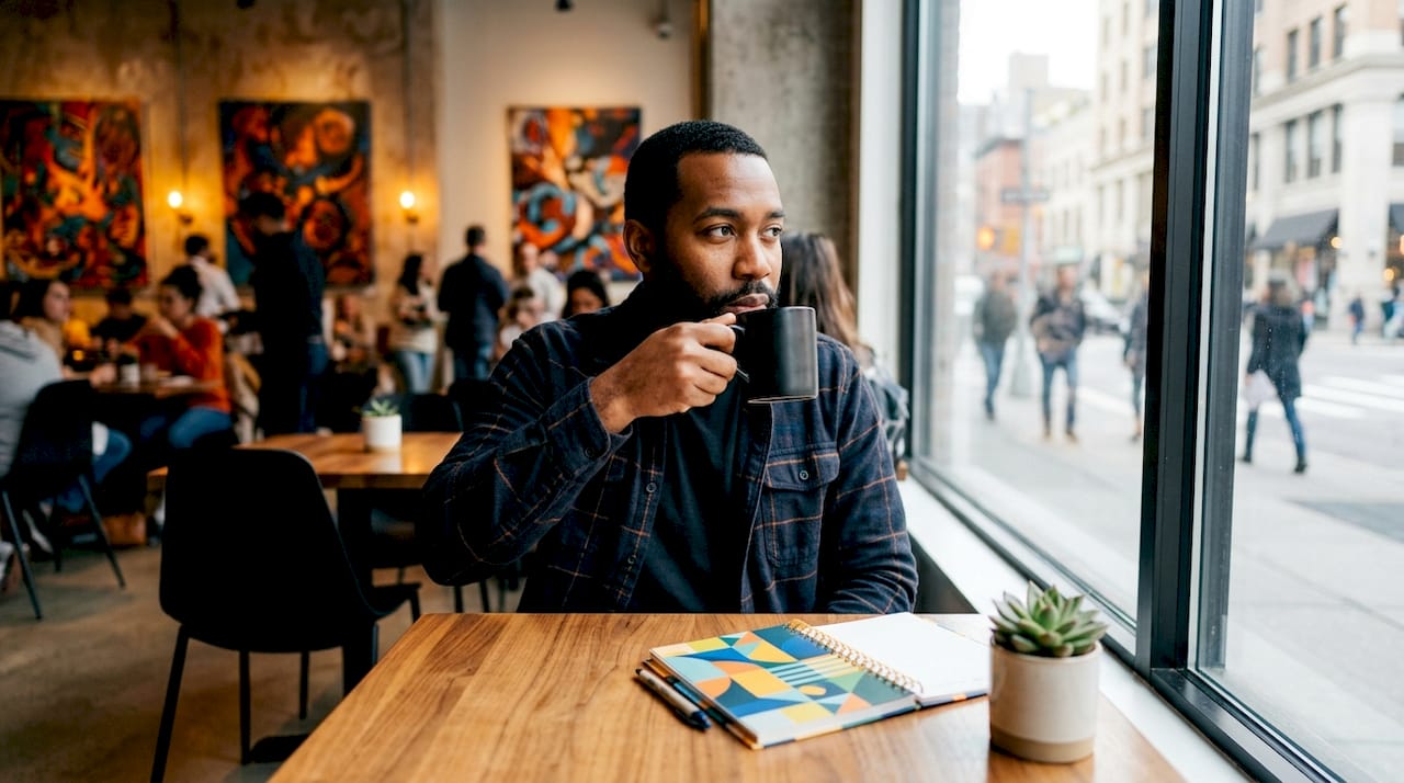 Man drinking coffee at kitchen bar morning