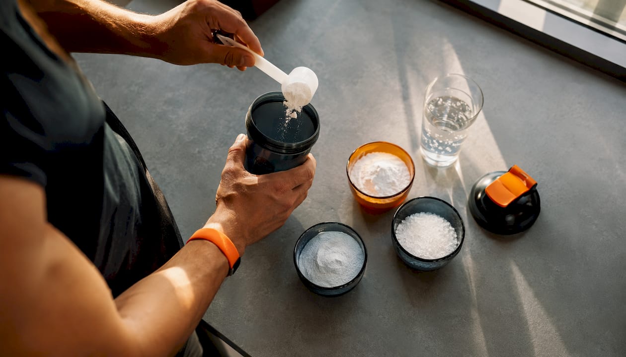 Close-up of hands holding pre-workout powders