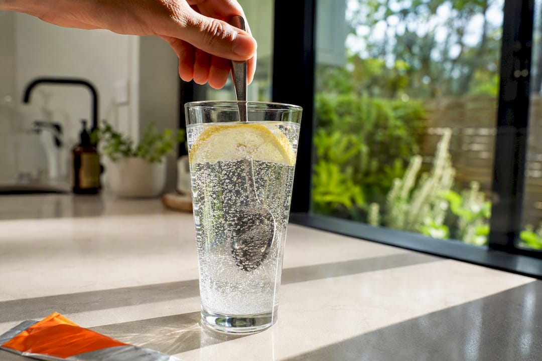 Glass of electrolyte water with lemon slice