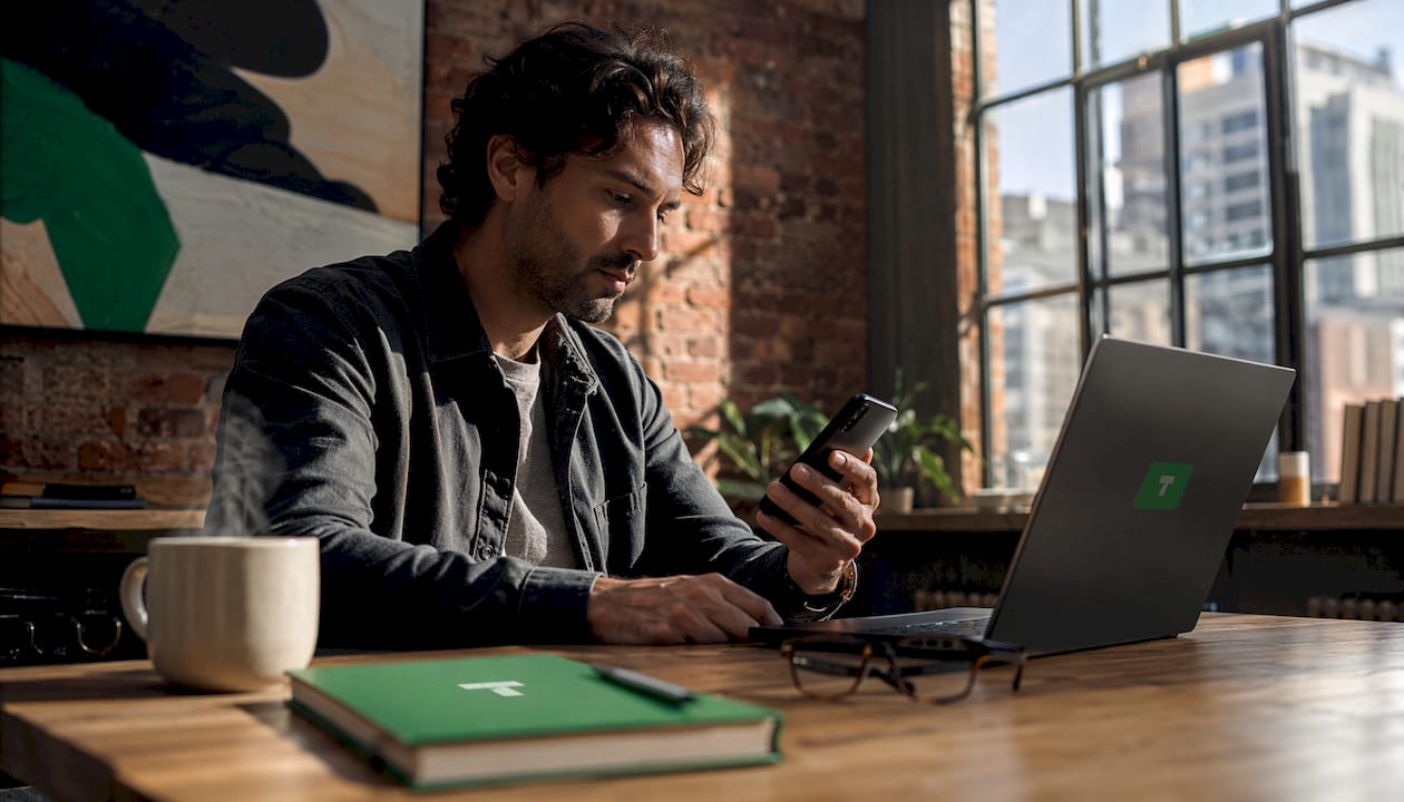 Creator using laptop and smartphone for tipping