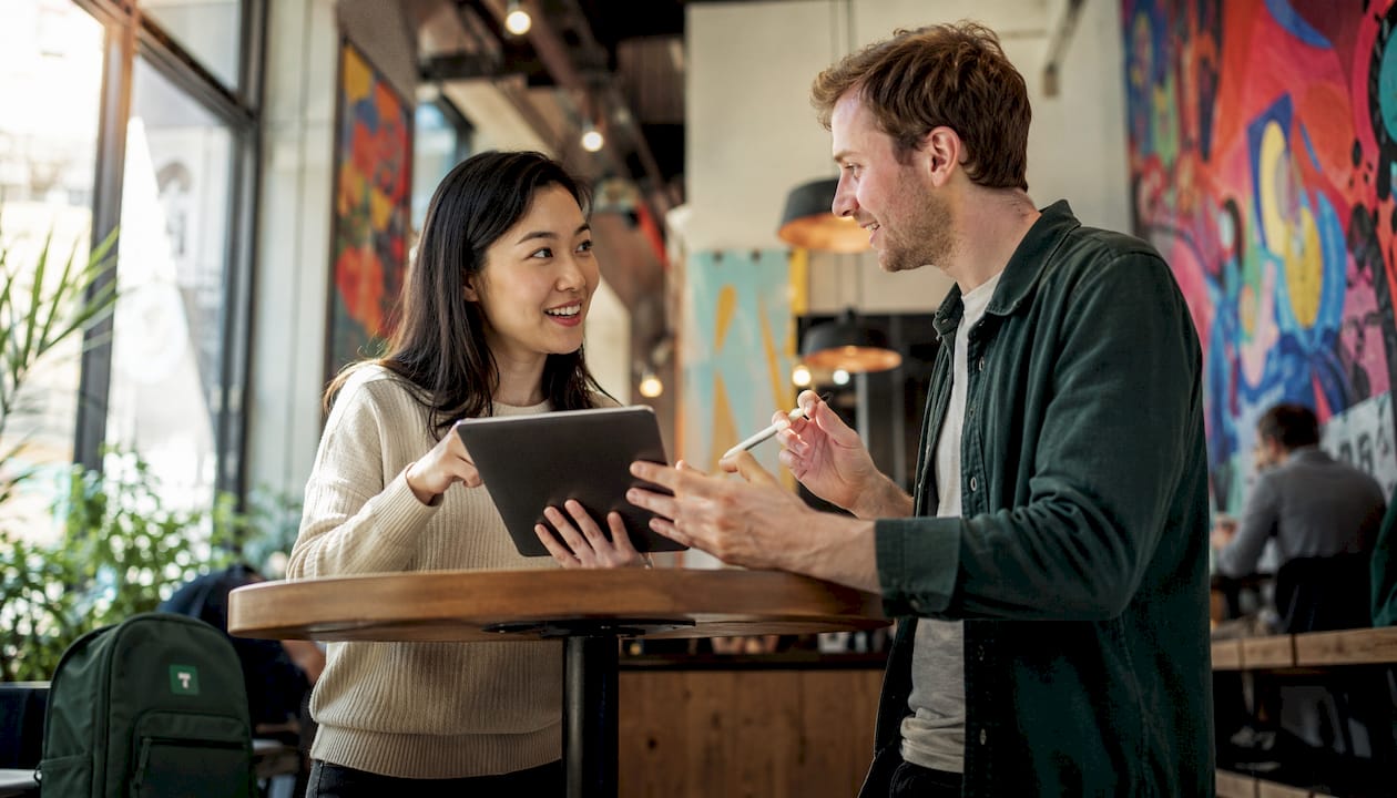 Two colleagues discussing payments platform