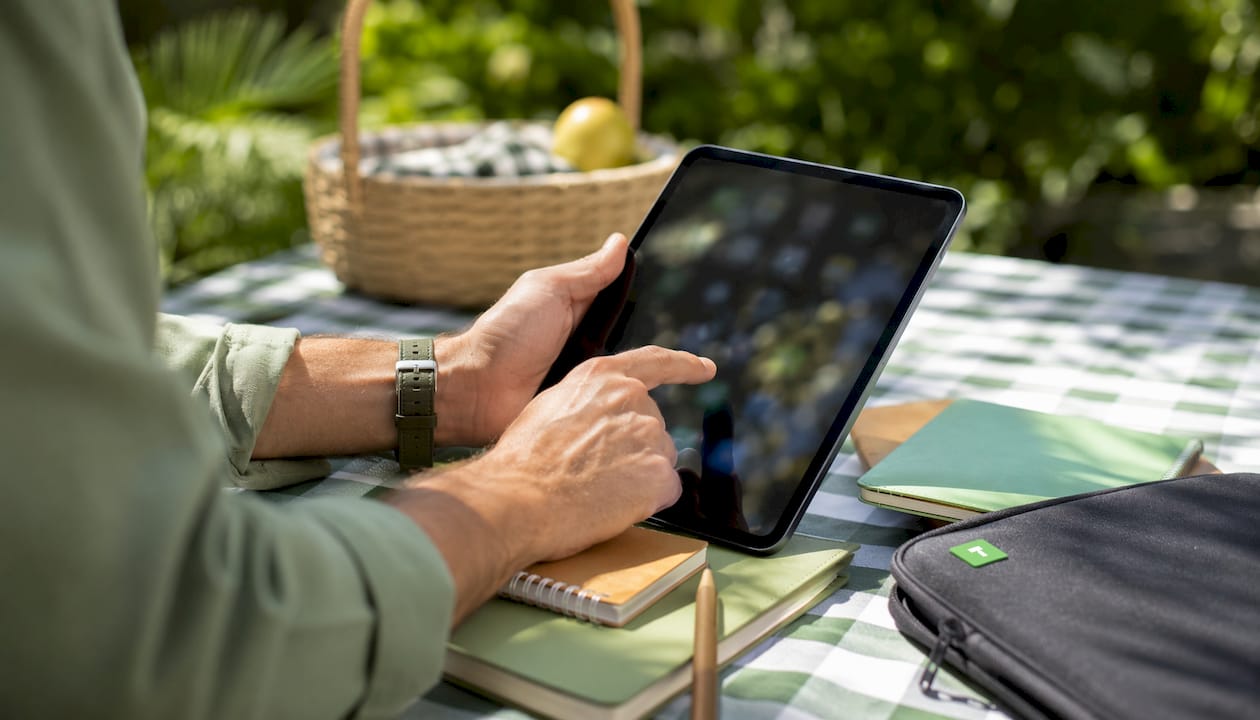 Hands using tablet with payment apps at café