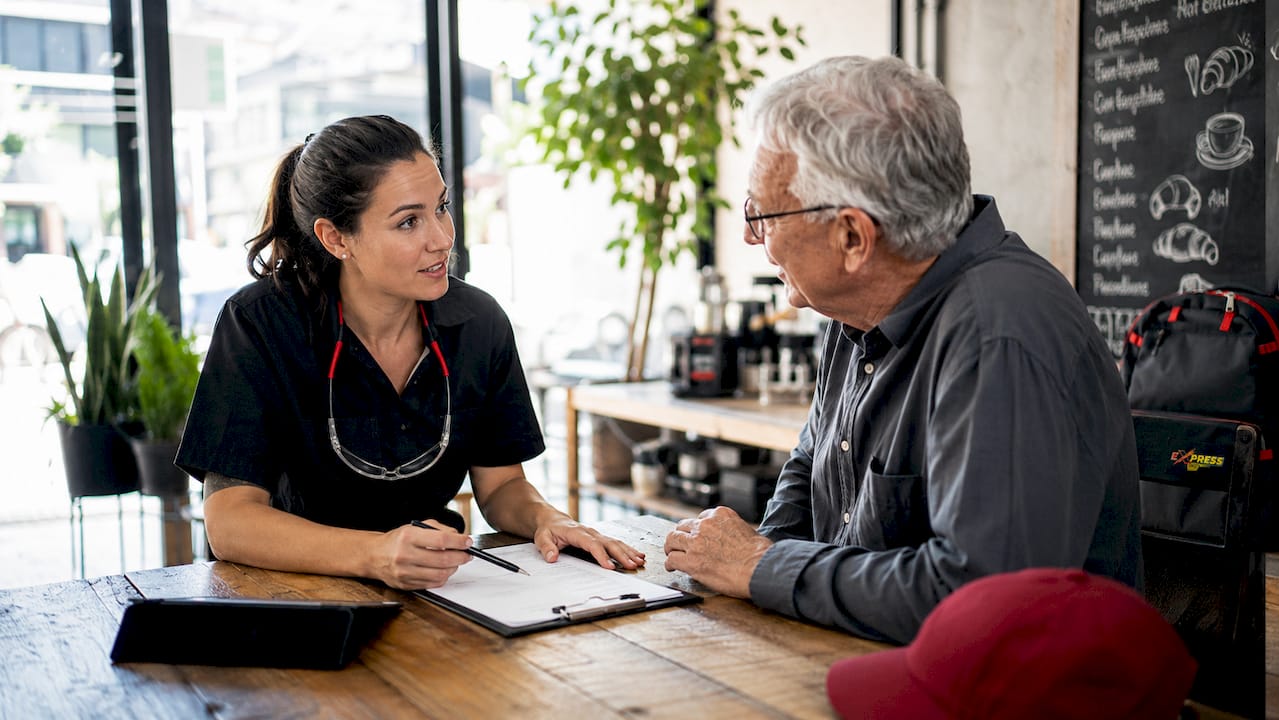 Mechanic discussing car service with customer