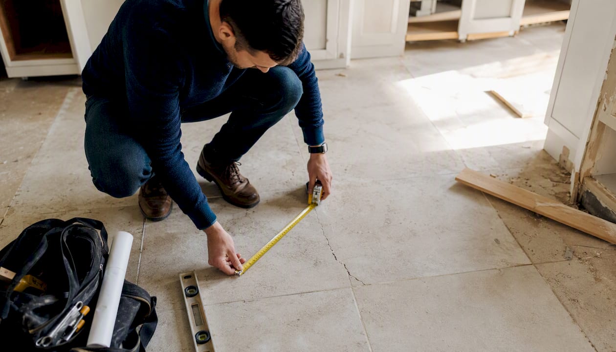 Investor measuring roof section onsite