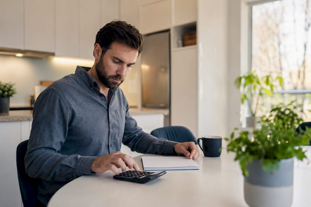 Investor calculating breakeven occupancy at desk