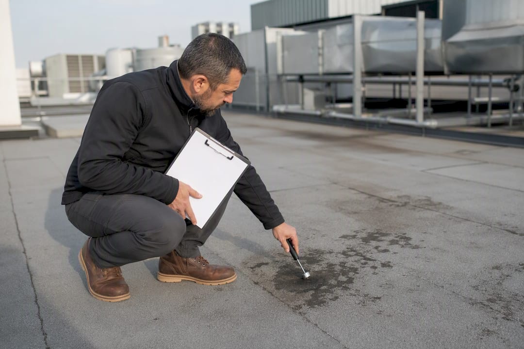 Contractor inspecting commercial roof condition
