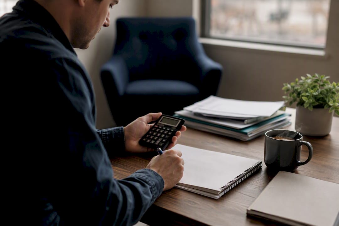 Investor calculating vacancy rates at desk