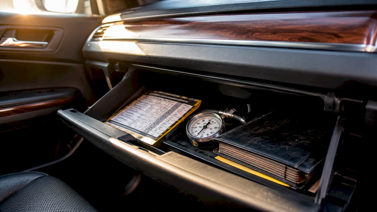 Car glove box with maintenance checklist and tools