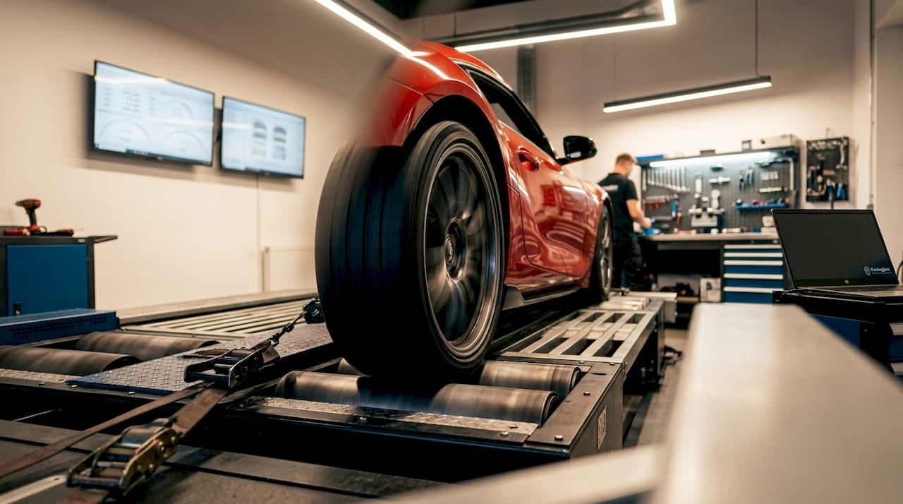 What Is Dyno Tuning? A Professional Guide Close-Up Of Performance Car Wheel On Dynamometer Roller