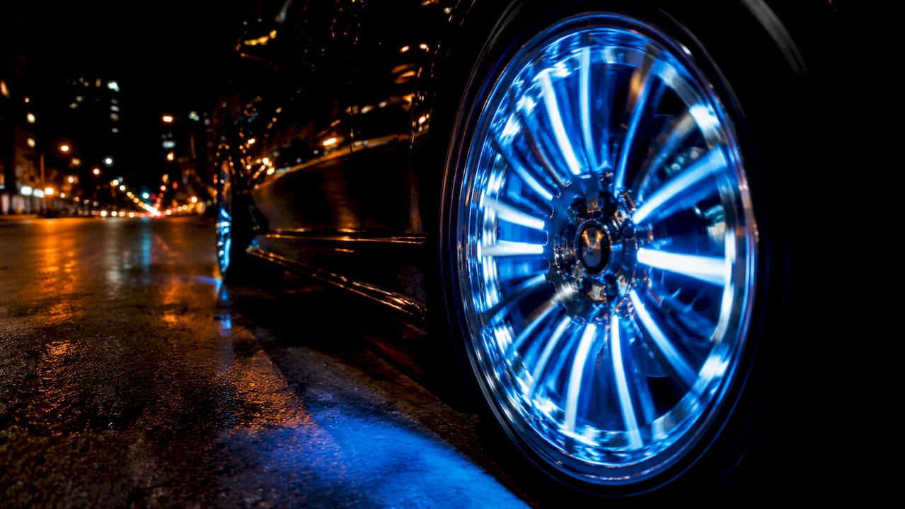 Close-up of illuminated spoke lighting on rotating wheel