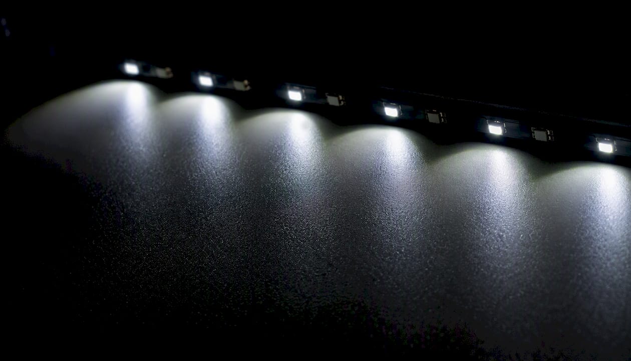 Close-up LED light cones overlap on strip