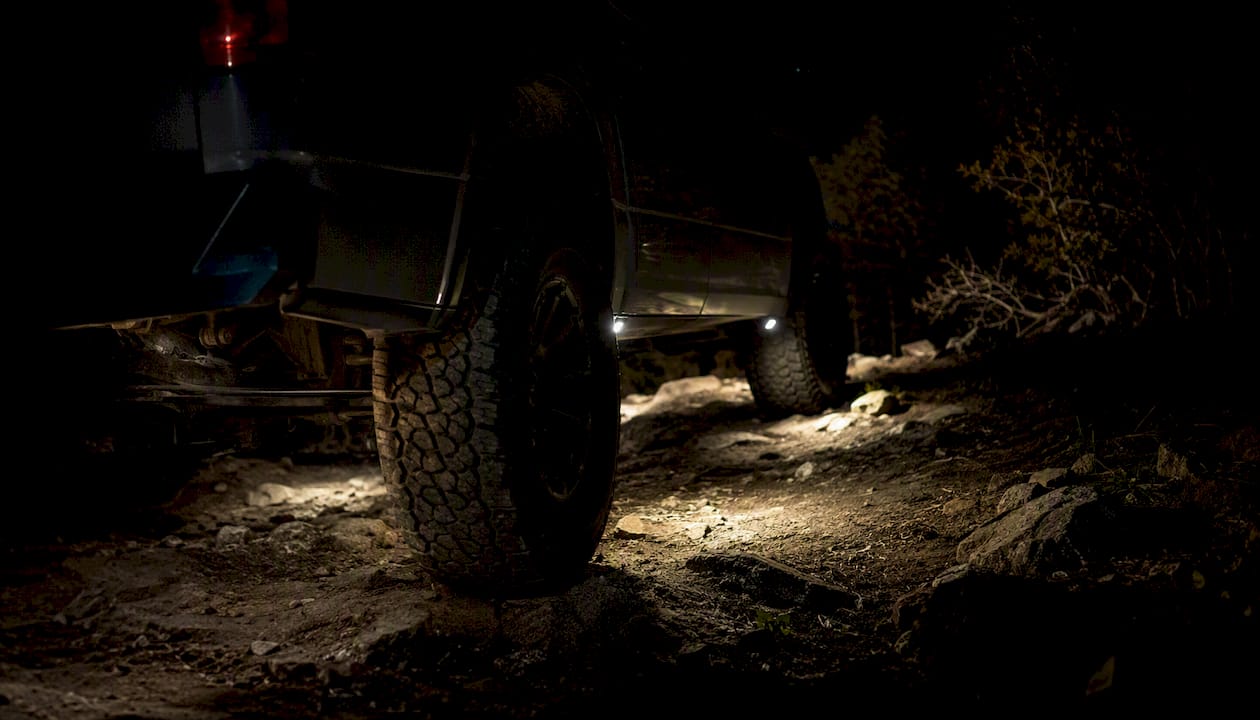 Rock lights aimed downward illuminating trail ground