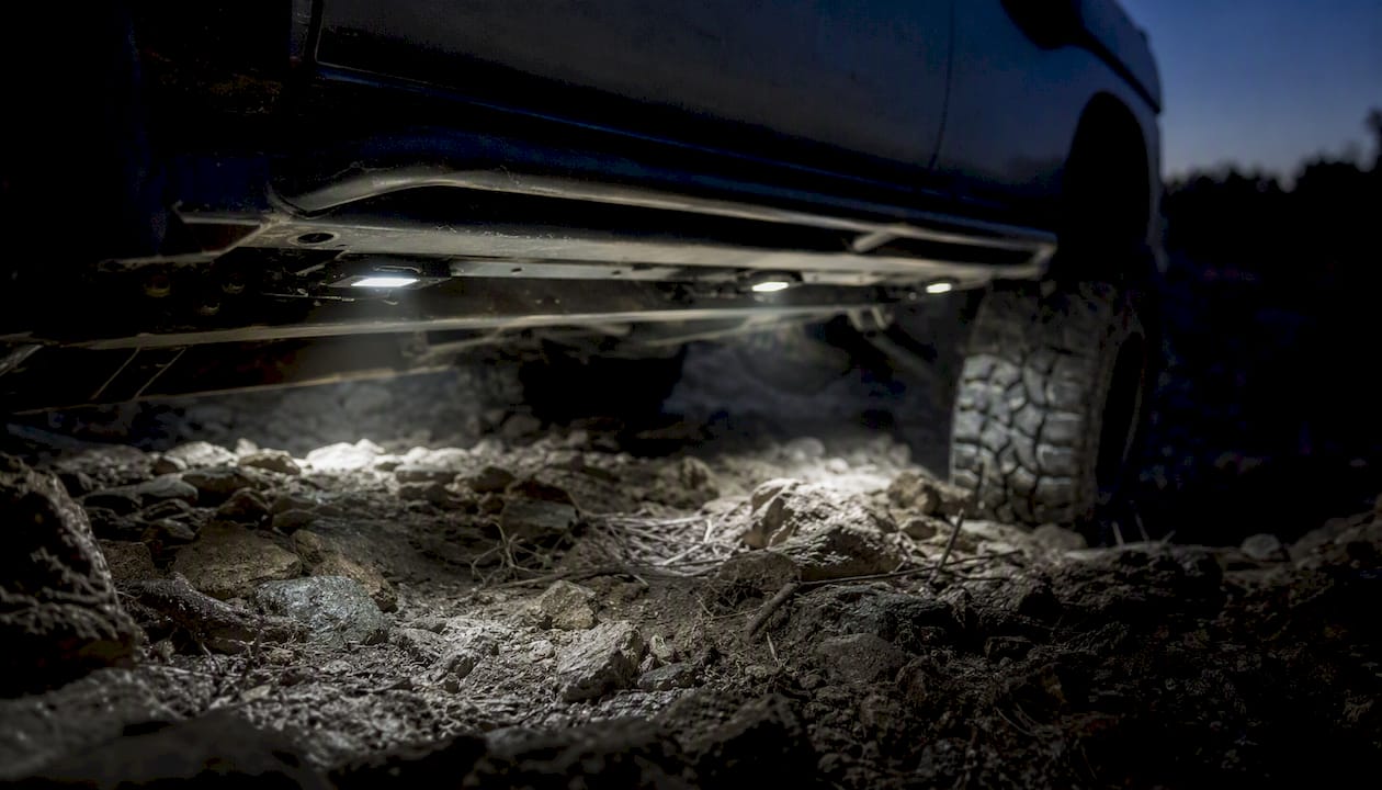 Rocker panel rock lights illuminating trail rocks