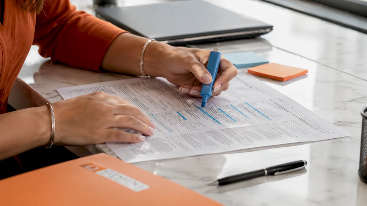 Hands highlighting precise text spans in medical report