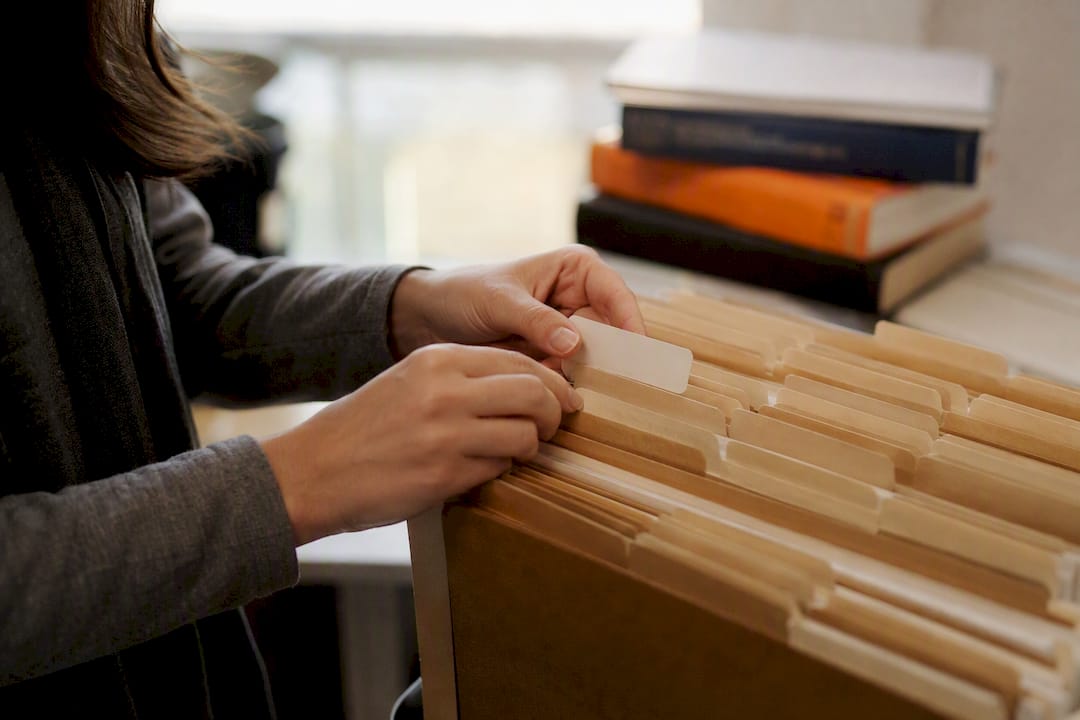 Hands indexing medical records folders