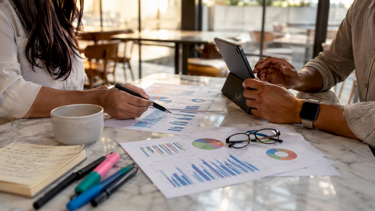 Hands of diverse team collaborating over email benchmarks