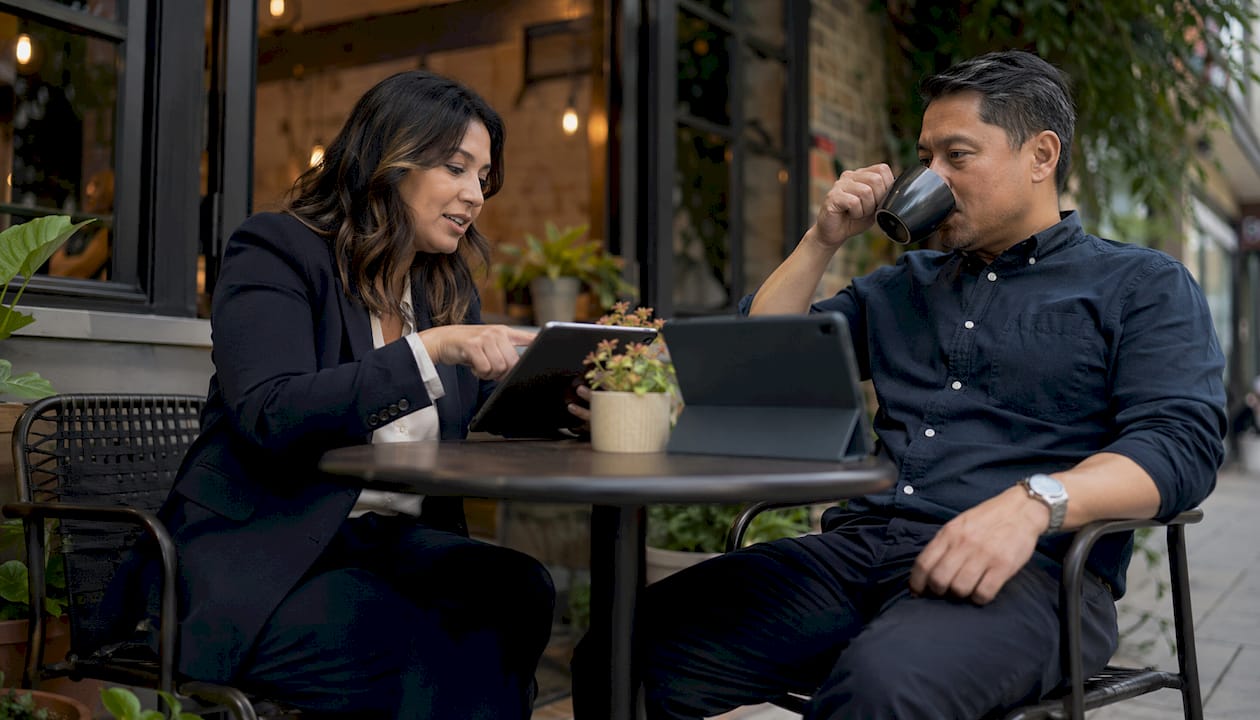 Two agents discussing referral program in conference room