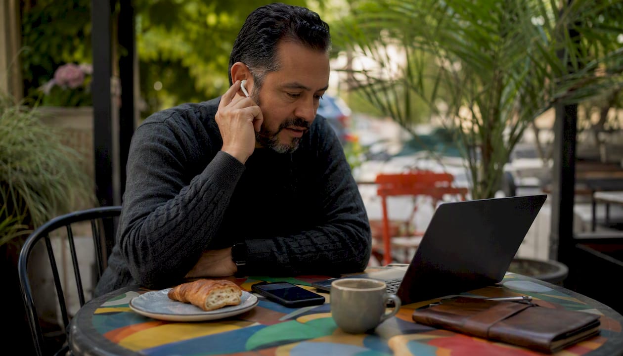 Man replying to social media comments in café
