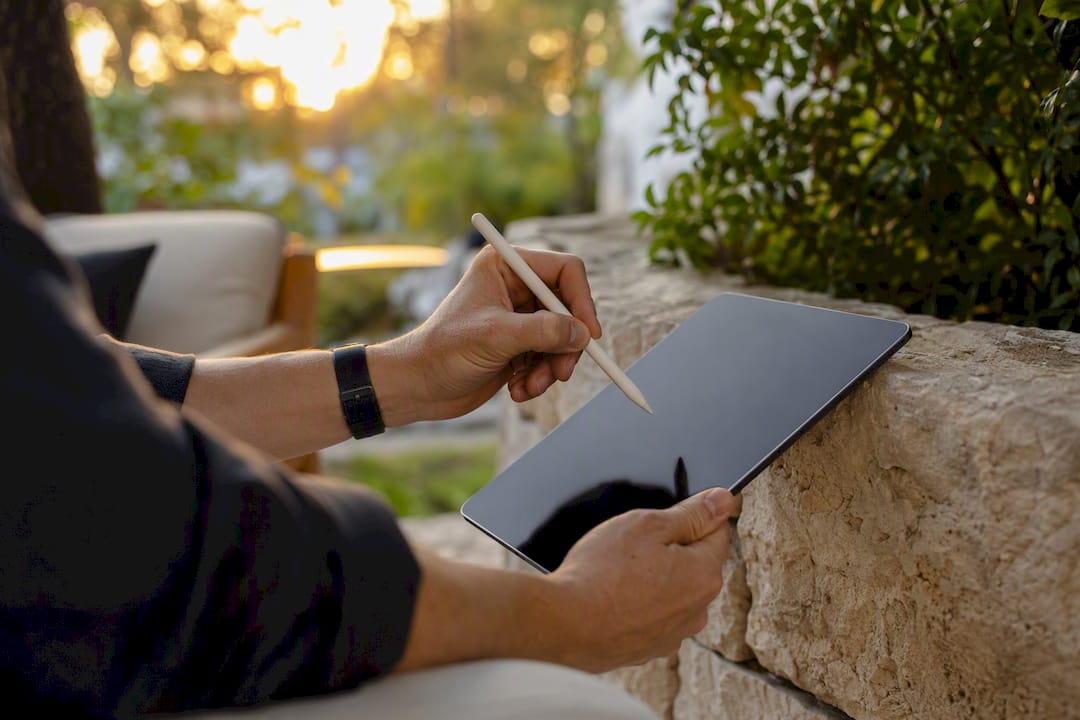 Hands editing email content on tablet