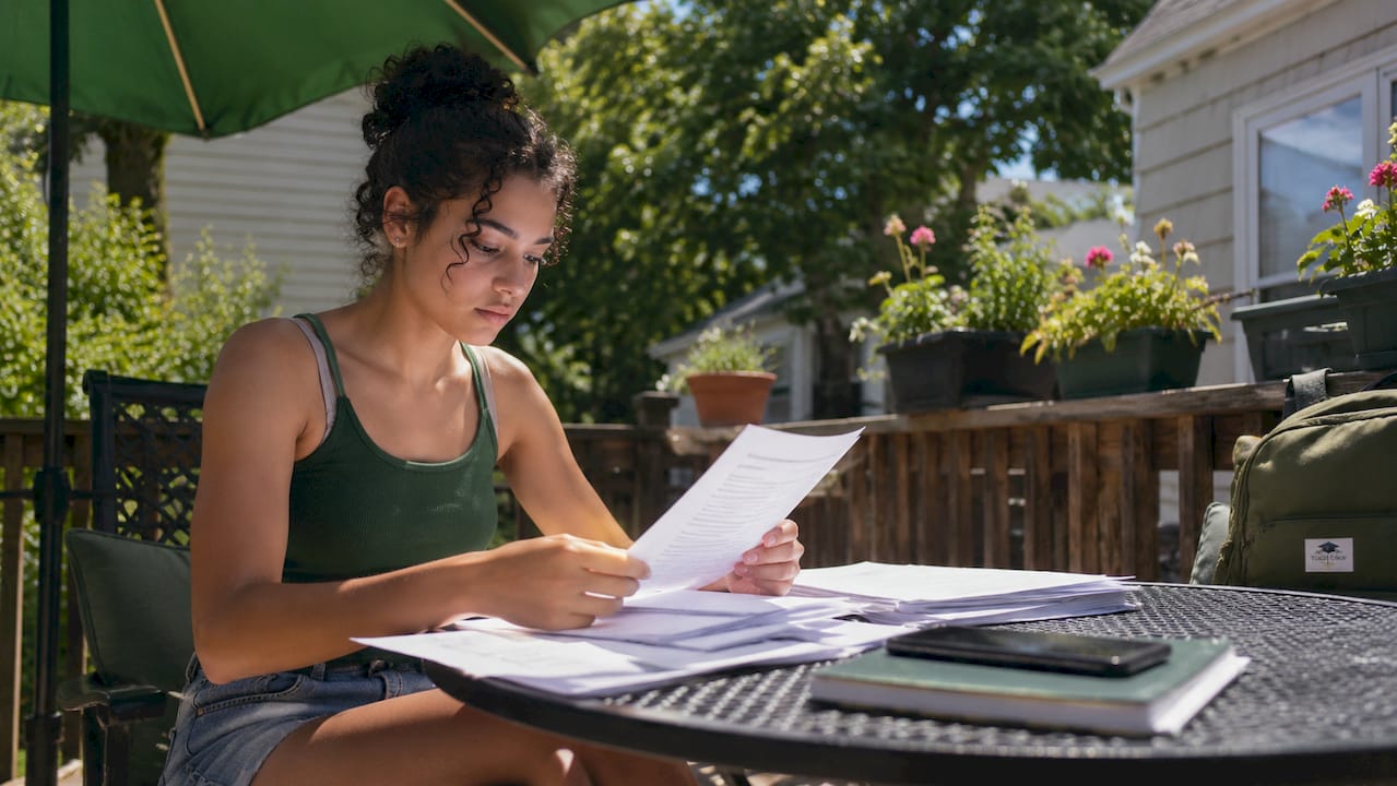 Student reviewing college fee waiver documents at home