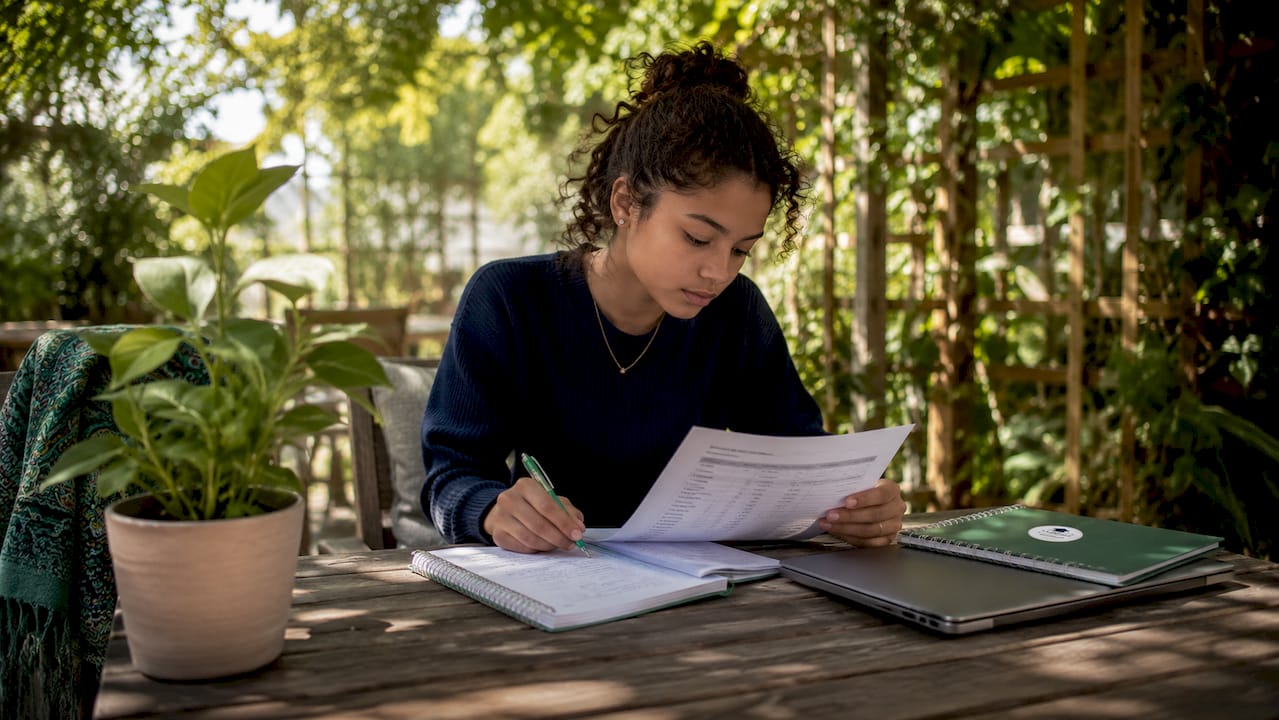 Student reviewing senior year grades at desk