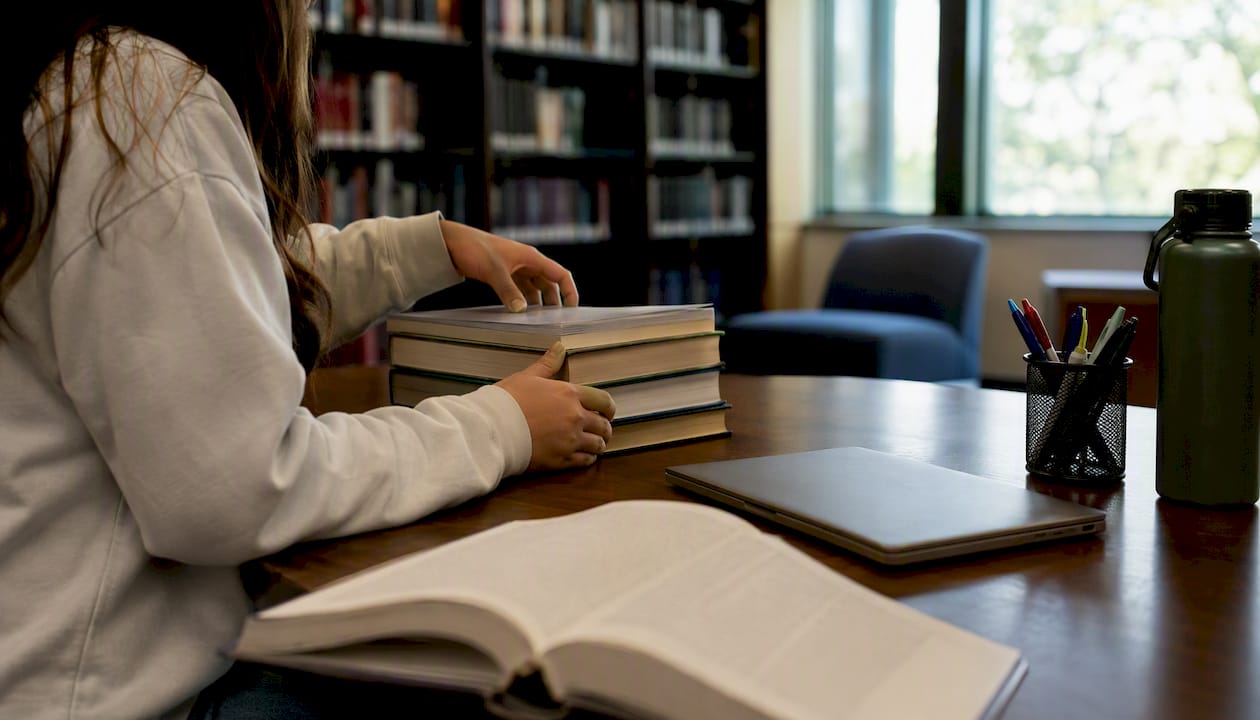 Student organizing study materials for tutoring session
