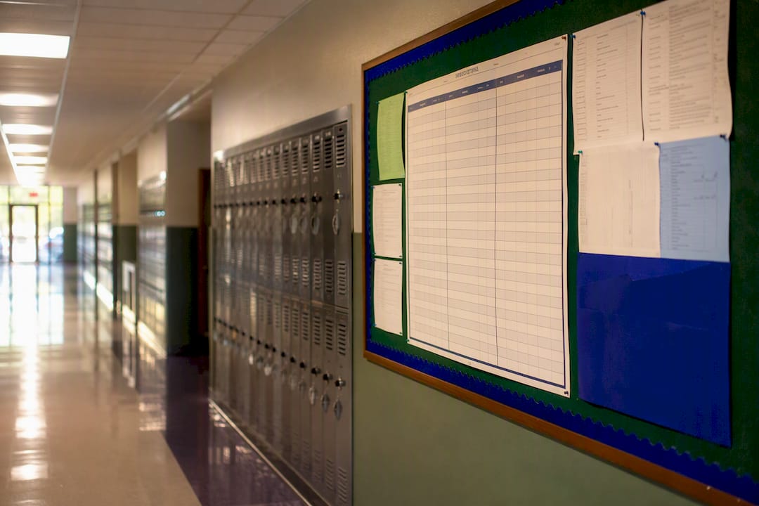 School hallway with lockers and bulletin board