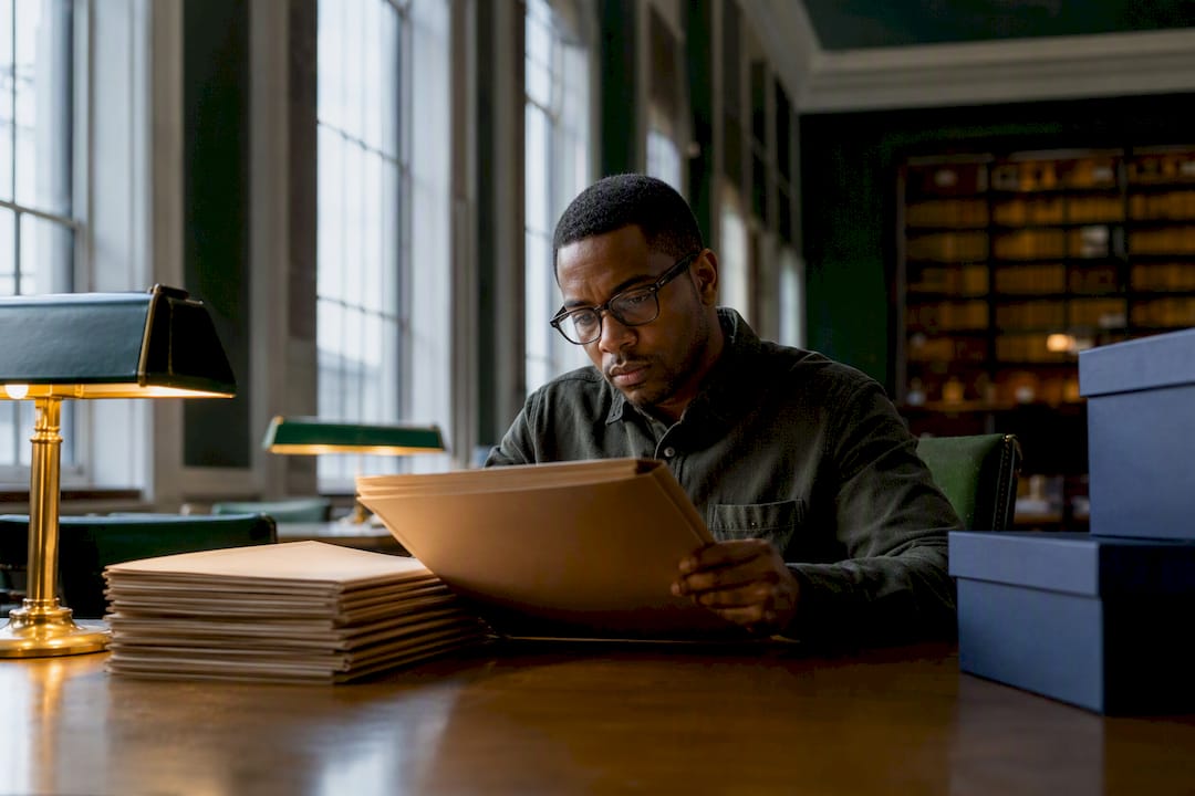 Admissions reader reviewing anonymized application folders