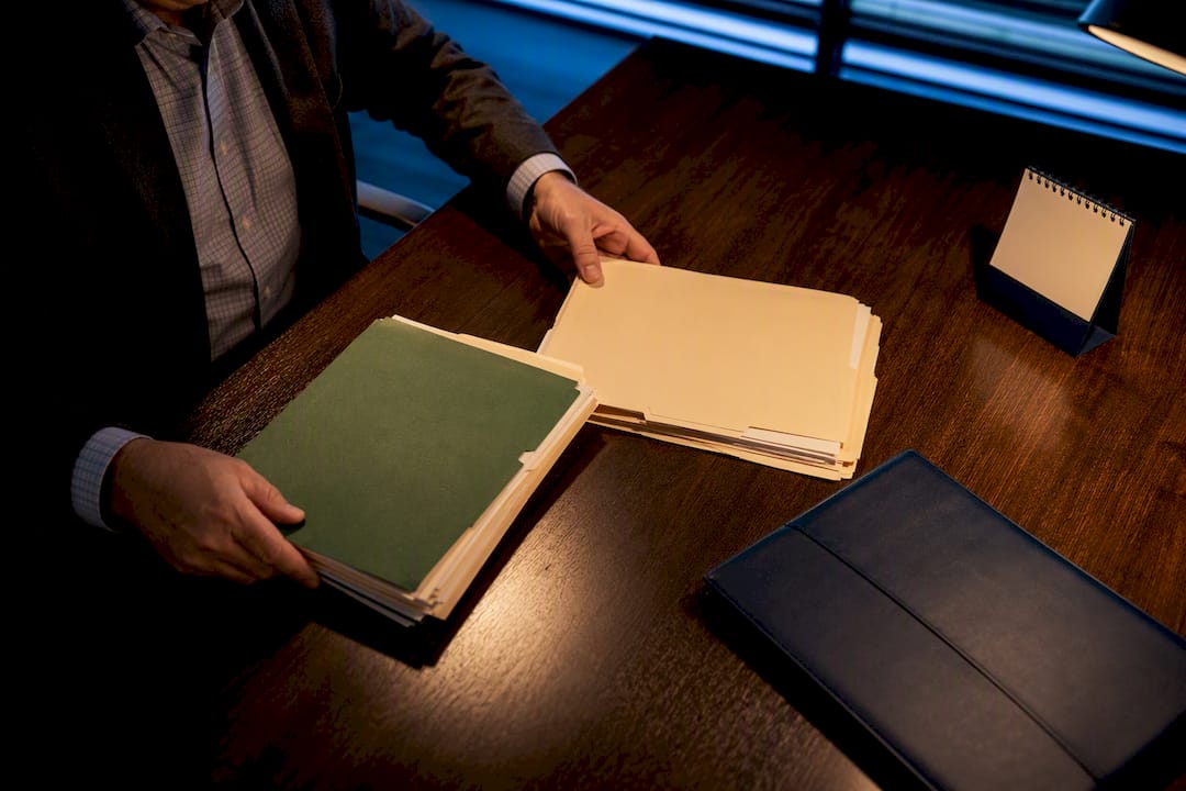 Admissions reader reviewing application folders