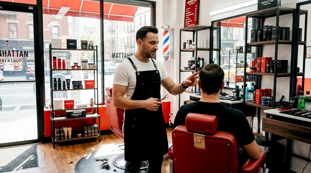 Barber discussing haircut correction with client