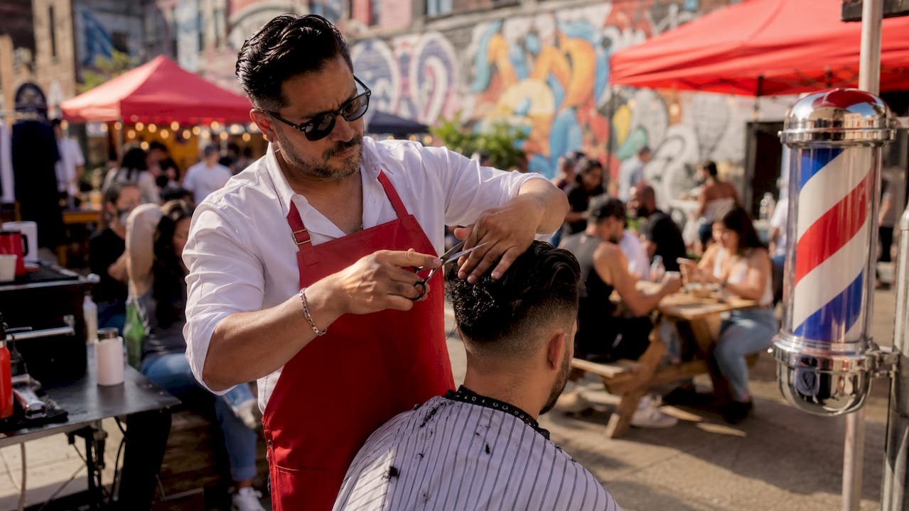 Busy chain barbershop barber cutting hair quickly