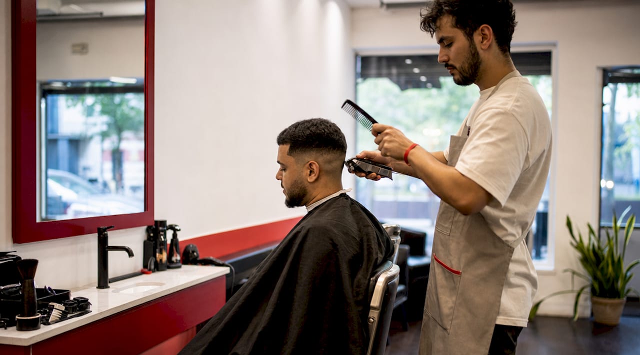 Child showing sensory distress in busy barbershop