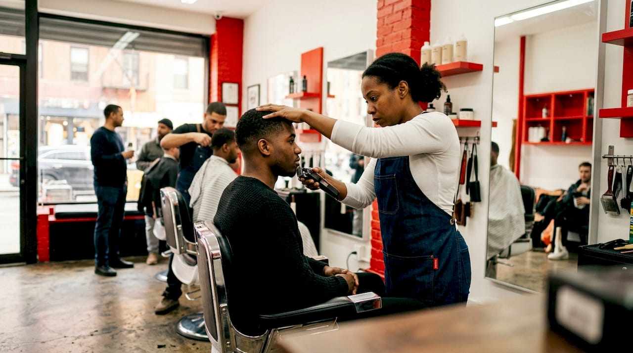 Barber creating a skin fade haircut on a young man