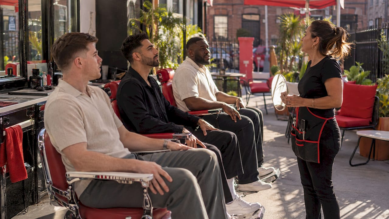 Barber assessing face shapes for style