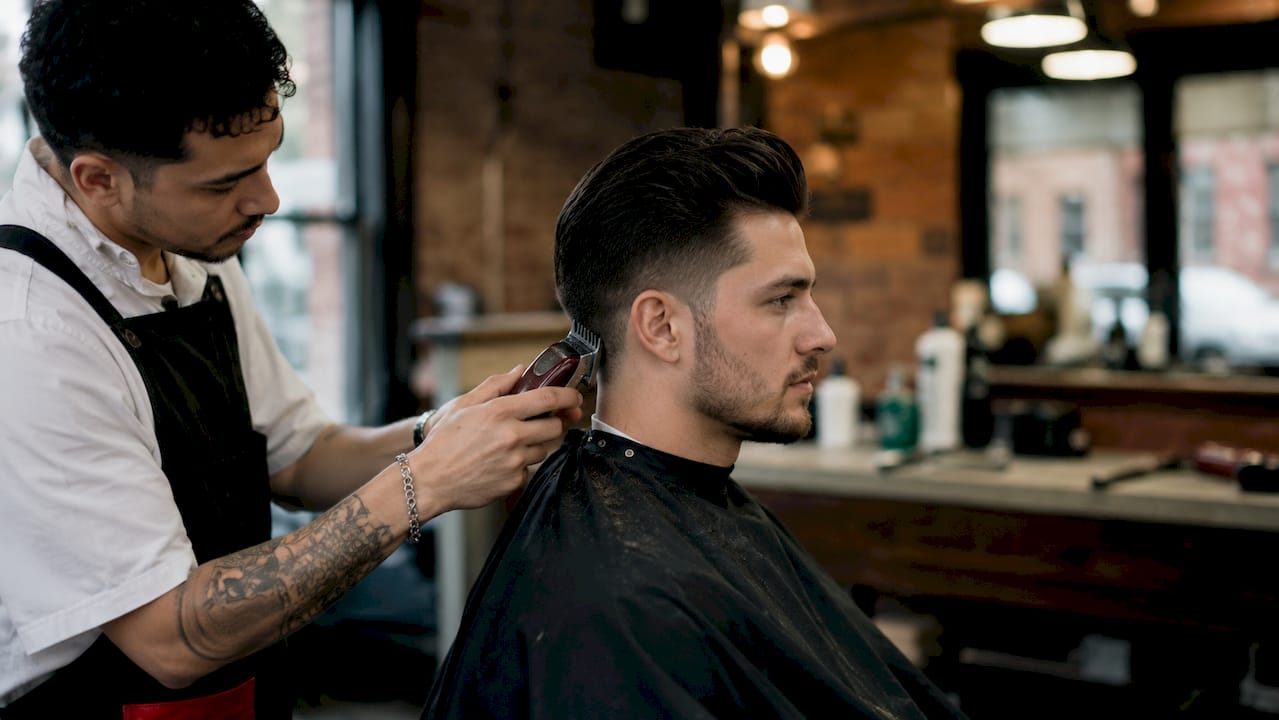 Boy receiving textured crop haircut in salon