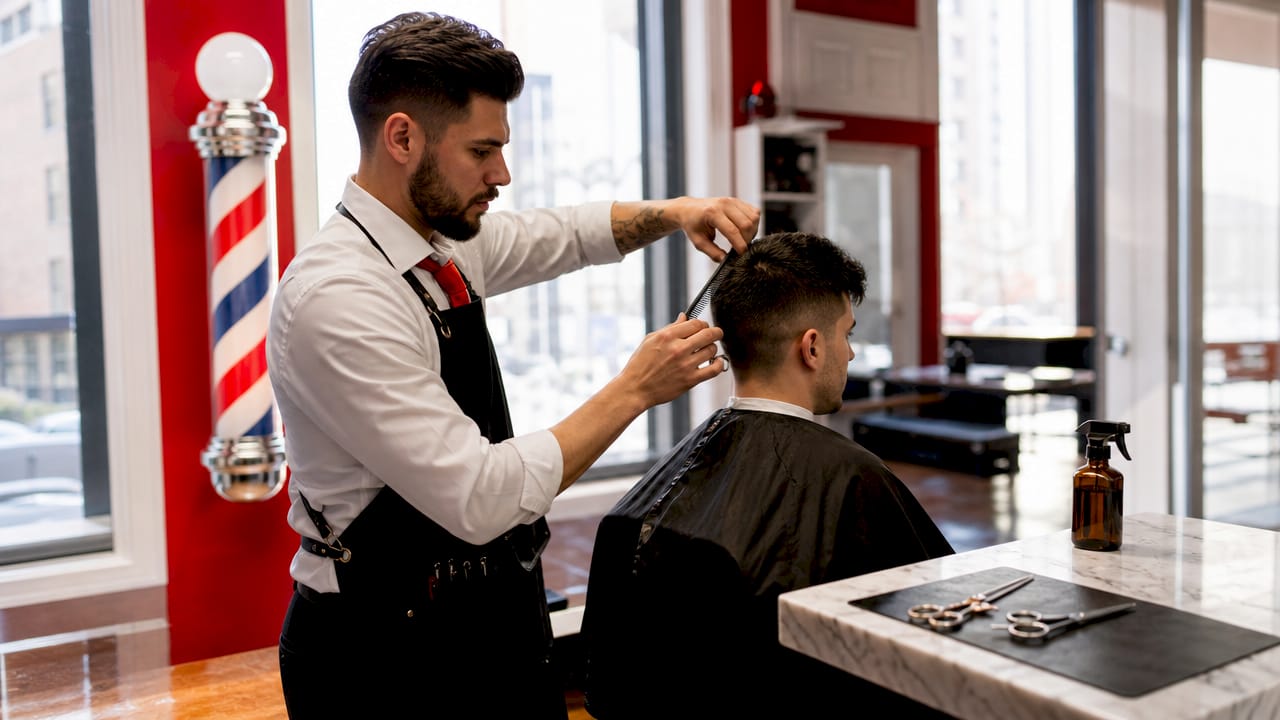 Barber practicing signature haircutting technique