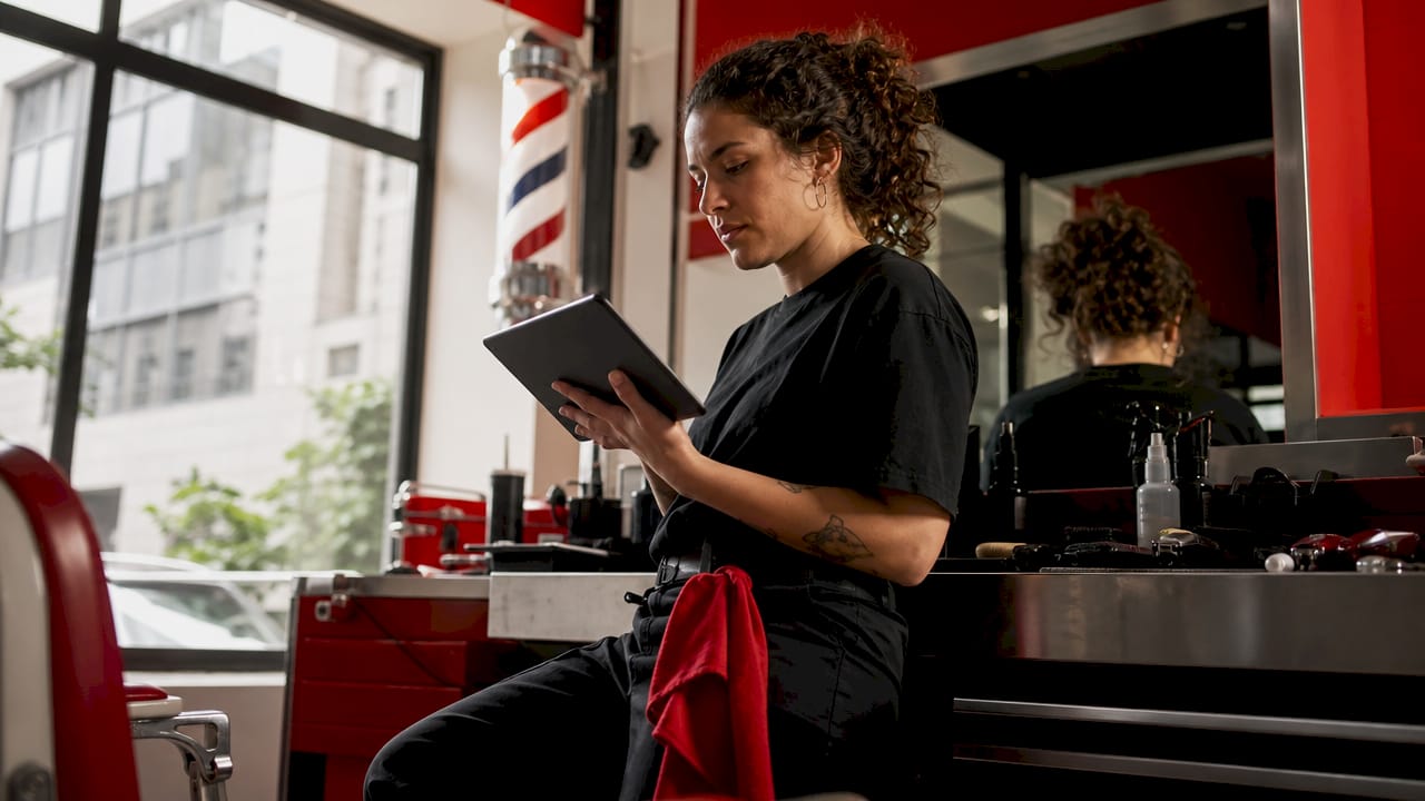 Barber watching haircut video for review