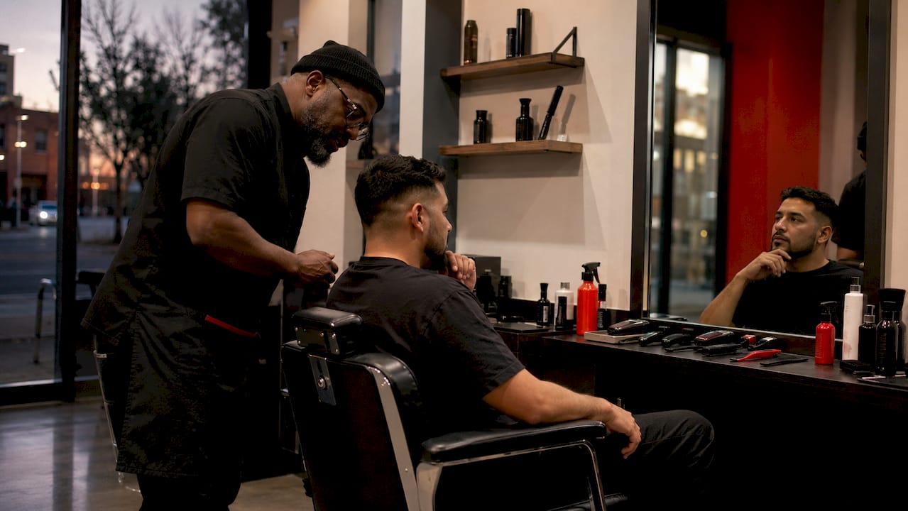 Barber consulting client about haircut preferences