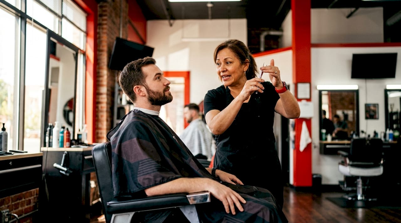 Barber consulting client before haircut