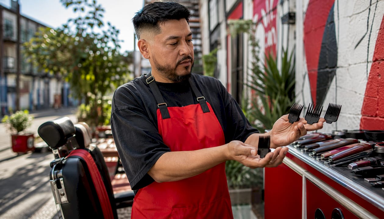 Barber comparing clipper guards for buzz cuts