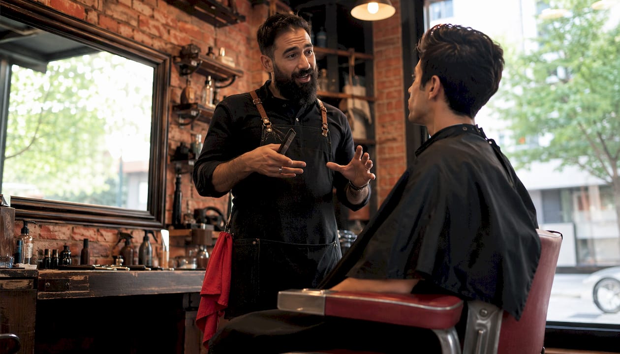 Barber consulting client before haircut