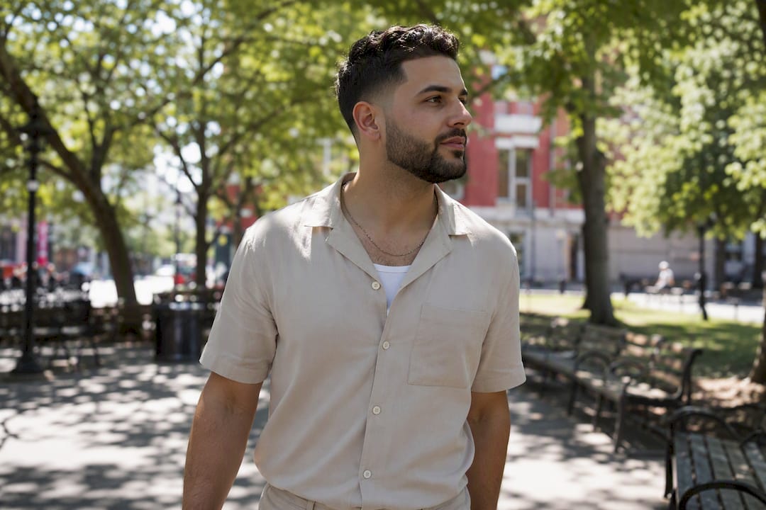 Young man with short beard in summer light