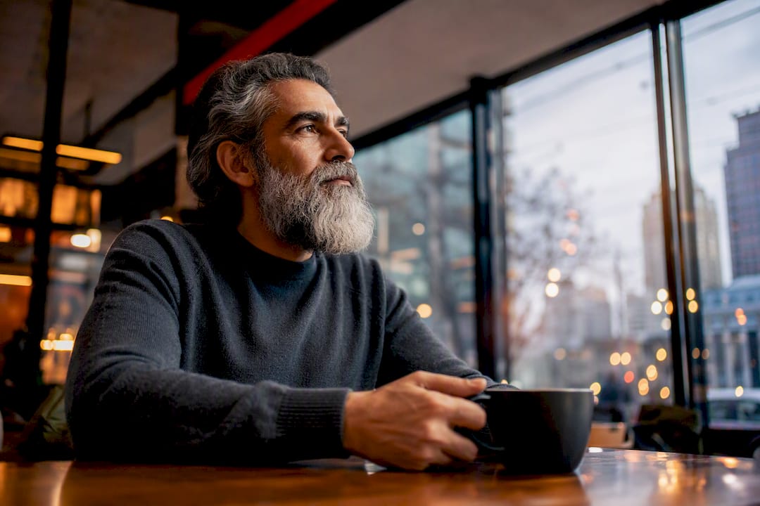 Mature man with well-groomed gray beard outdoors