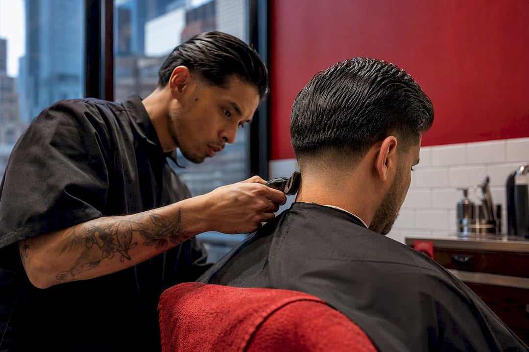Barber creating a classic taper haircut